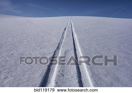 Stock Photo - Tire tracks in snowy landscape. Fotosearch