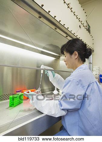 Stock Image - Vietnamese scientist working in laboratory. Fotosearch