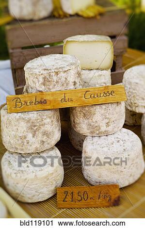 Stock Image - Wheels of cheese for sale in market. Fotosearch