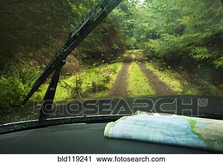 Stock Image - Windshield wipers and map on dashboard of car. Fotosearch