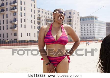 Stock Photo - Woman laughing on beach. Fotosearch