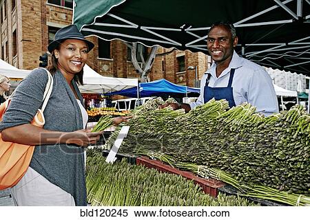 Woman shopping at outdoor market View Large Photo Image Stock Photography - Woman shopping at outdoor market. Fotosearch