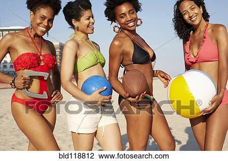 Women holding balls on beach View Large Photo Image Stock Image - Women holding balls on beach. Fotosearch