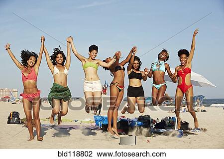 Women jumping for joy on beach View Large Photo Image Stock Image - Women jumping for joy on beach. Fotosearch