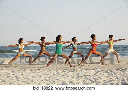 Women practicing yoga on beach View Large Photo Image Stock Image - Women practicing yoga on beach. Fotosearch