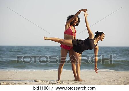 Women practicing yoga on beach View Large Photo Image Stock Photo - Women practicing yoga on beach. Fotosearch