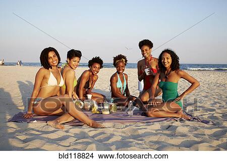 Picture - Women relaxing together on beach. Fotosearch