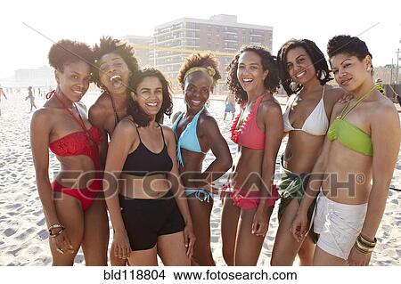 Picture - Women smiling together on beach. Fotosearch
