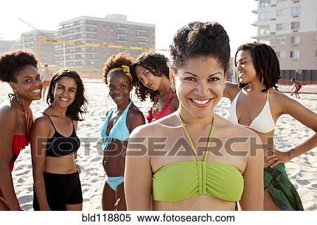 Stock Photography - Women smiling together on beach. Fotosearch