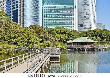 Stock Image - Wooden bridge over urban waterfront, Tokyo, Japan. Fotosearch