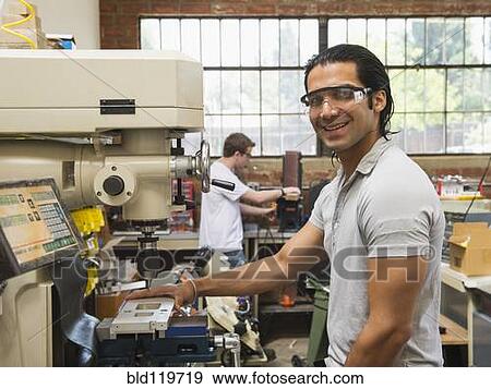 Workers using machinery in machine shop View Large Photo Image Stock Photo - Workers using machinery in machine shop. Fotosearch