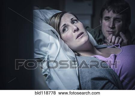 Stock Photo - Worried couple in hospital bed. Fotosearch
