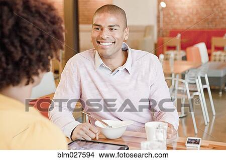 Picture - African American business people working in cafe. Fotosearch