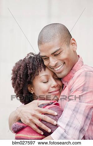 Stock Photo - African American couple hugging. Fotosearch