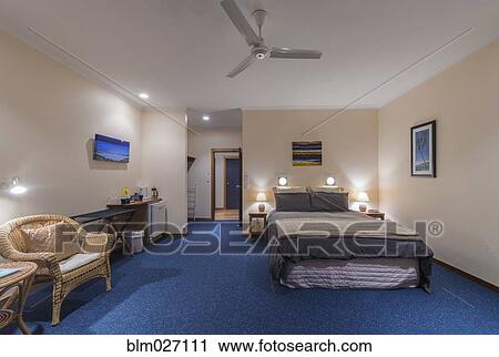 Bed and armchair in hotel room View Large Photo Image Stock Image - Bed and armchair in hotel room. Fotosearch
