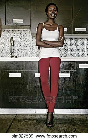 Black woman smiling in kitchen View Large Photo Image Stock Photo - Black woman smiling in kitchen. Fotosearch