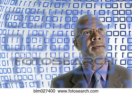 Stock Image - Businessman reading binary code. Fotosearch