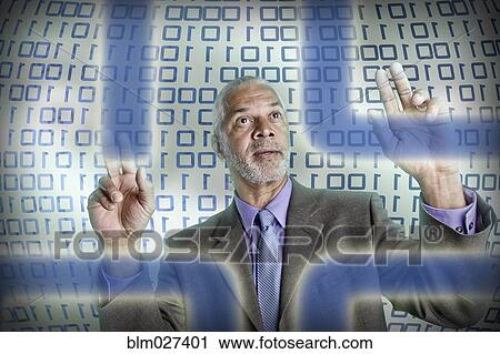 Stock Image - Businessman reading binary code. Fotosearch