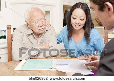 Businessman talking to clients in kitchen View Large Photo Image Stock Image - Businessman talking to clients in kitchen. Fotosearch