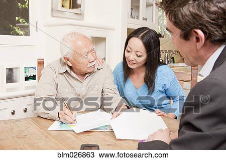 Businessman talking to clients in kitchen View Large Photo Image Stock Image - Businessman talking to clients in kitchen. Fotosearch