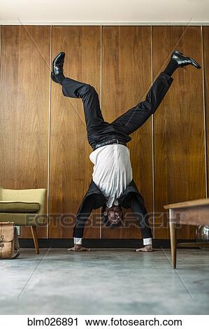 Caucasian businessman doing handstand View Large Photo Image Stock Image - Caucasian businessman doing handstand. Fotosearch
