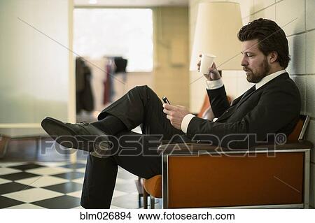 Picture - Caucasian businessman using cell phone. Fotosearch