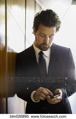 Caucasian businessman using cell phone View Large Photo Image Stock Photography - Caucasian businessman using cell phone. Fotosearch