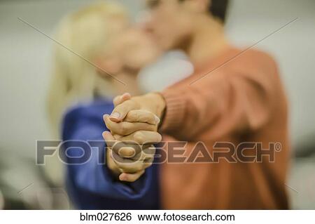 Stock Photograph - Caucasian couple holding hands. Fotosearch