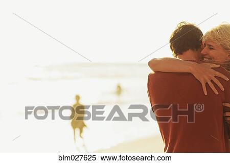 Caucasian couple hugging on beach View Large Photo Image Stock Photography - Caucasian couple hugging on beach. Fotosearch