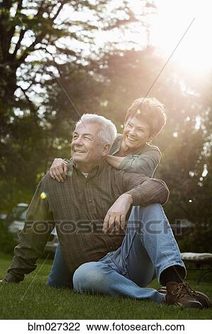 Caucasian couple relaxing outdoors View Large Photo Image Stock Image - Caucasian couple relaxing outdoors. Fotosearch