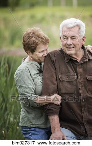 Caucasian couple relaxing outdoors View Large Photo Image Stock Photo - Caucasian couple relaxing outdoors. Fotosearch