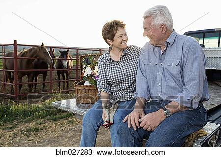 Caucasian couple sitting on tailgate near horse corral View Large Photo Image Stock Image - Caucasian couple sitting on tailgate near horse corral. Fotosearch