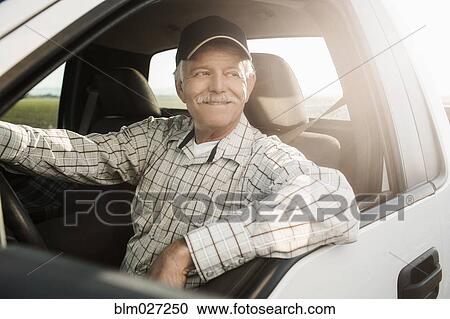 Caucasian farmer driving truck View Large Photo Image Stock Image - Caucasian farmer driving truck. Fotosearch