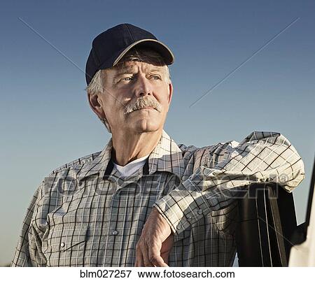 Caucasian farmer looking away View Large Photo Image Stock Photo - Caucasian farmer looking away. Fotosearch