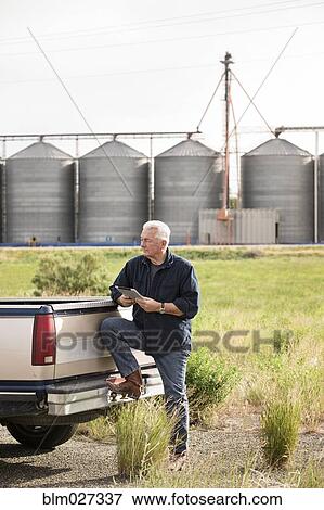 Caucasian farmer using digital tablet View Large Photo Image Stock Photo - Caucasian farmer using digital tablet. Fotosearch