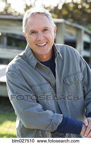 Caucasian man smiling outdoors View Large Photo Image Stock Image - Caucasian man smiling outdoors. Fotosearch