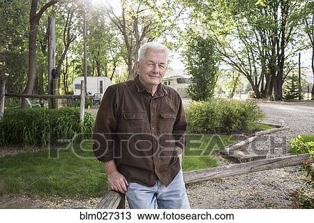 Caucasian man standing at campground View Large Photo Image Stock Image - Caucasian man standing at campground. Fotosearch