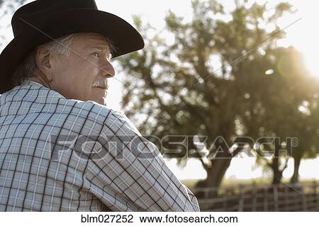 Caucasian rancher looking away View Large Photo Image Stock Image - Caucasian rancher looking away. Fotosearch
