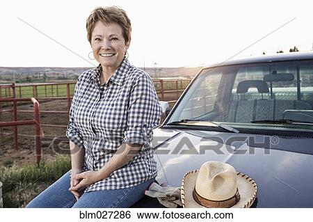 Caucasian rancher sitting on truck View Large Photo Image Stock Photograph - Caucasian rancher sitting on truck. Fotosearch