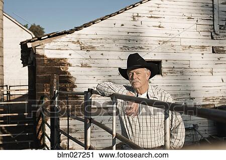 Caucasian rancher standing at gate View Large Photo Image Stock Image - Caucasian rancher standing at gate. Fotosearch