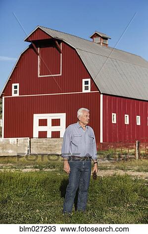 Caucasian rancher standing near barn View Large Photo Image Stock Image - Caucasian rancher standing near barn. Fotosearch