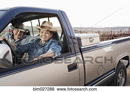 Stock Photo - Caucasian ranchers driving truck. Fotosearch