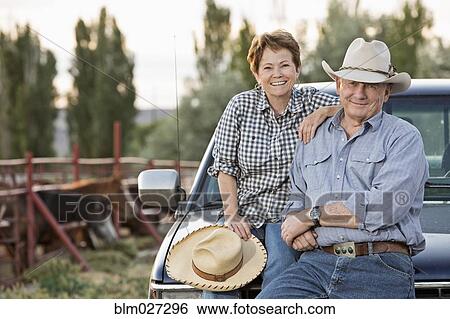 Caucasian ranchers sitting against truck View Large Photo Image Stock Photograph - Caucasian ranchers sitting against truck. Fotosearch