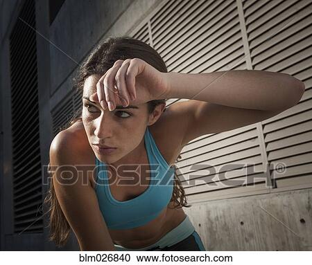 Caucasian runner wiping sweat off forehead View Large Photo Image Stock Image - Caucasian runner wiping sweat off forehead. Fotosearch