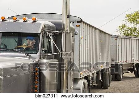 Caucasian trucker driving semi-truck View Large Photo Image Stock Image - Caucasian trucker driving semi-truck. Fotosearch
