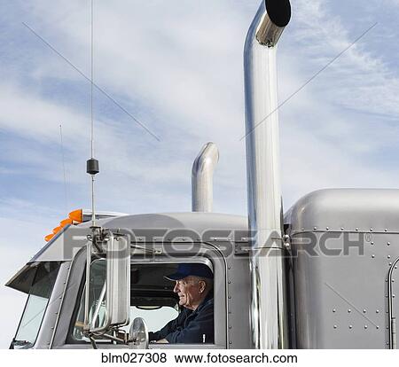 Caucasian trucker driving semi-truck View Large Photo Image Stock Photo - Caucasian trucker driving semi-truck. Fotosearch