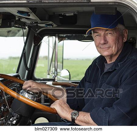 Caucasian trucker driving semi-truck View Large Photo Image Stock Photo - Caucasian trucker driving semi-truck. Fotosearch