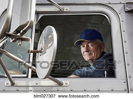 Caucasian trucker sitting in semi-truck View Large Photo Image Stock Photo - Caucasian trucker sitting in semi-truck. Fotosearch