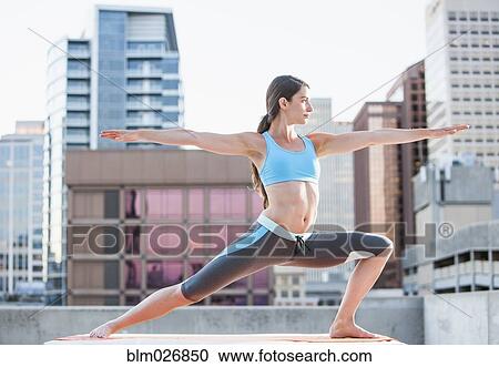 Caucasian woman practicing yoga on urban rooftop View Large Photo Image Stock Image - Caucasian woman practicing yoga on urban rooftop. Fotosearch