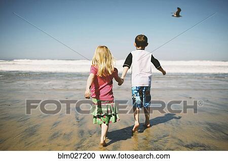 Children walking together on beach View Large Photo Image Stock Image - Children walking together on beach. Fotosearch